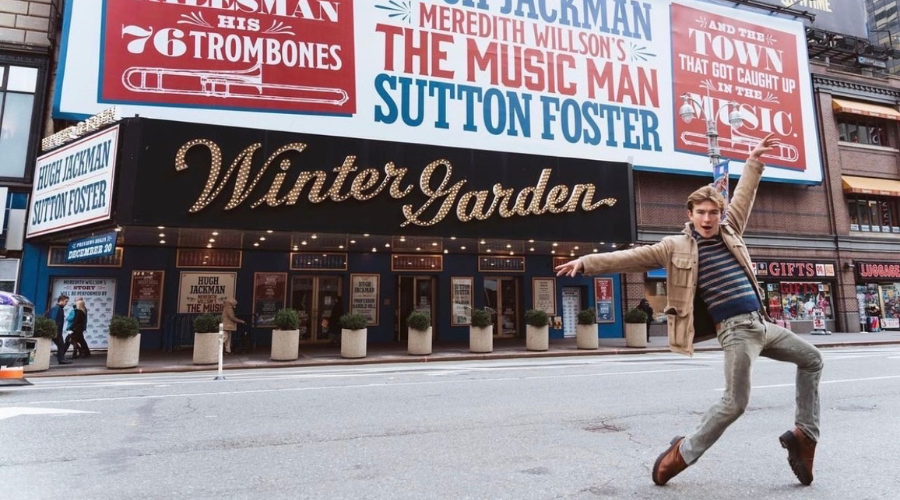 Drew Minard '25GS posing in front of the Winter Garden Theatre.