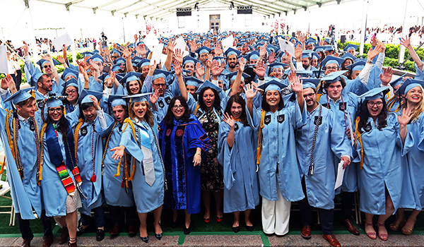 Students celebrate Class Day in their caps and gowns.