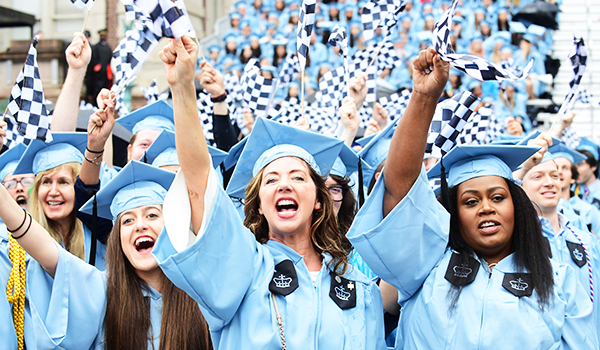 Students celebrate Commencement in their caps and gowns.