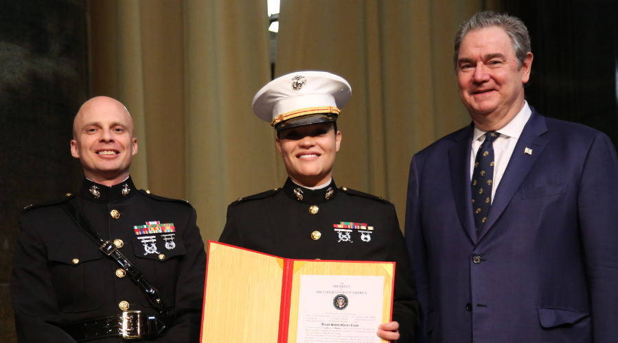 Alaura Gogue '23GS receiving her commissioning scroll