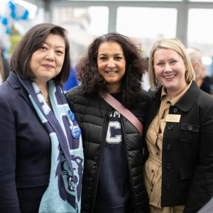 2 alumni pose for a photo with Jill Galas Hickey, Associate Dean for Development and Alumni Relations, at Homecoming Luncheon