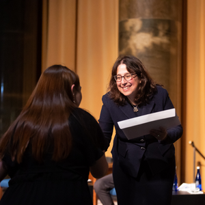 Dean Rosen-Metsch presents a student with their certificate