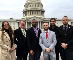 Kris Goldsmith and colleagues stand in front of the U.S. Capitol Building