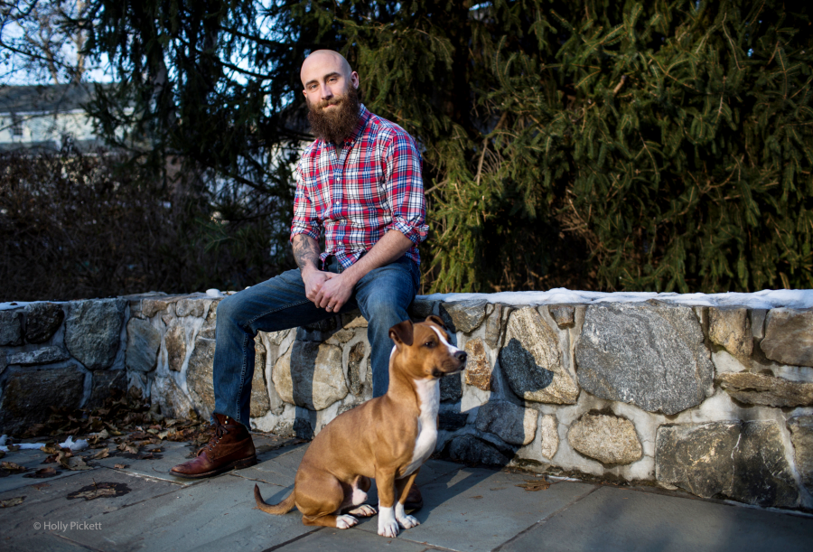 Kristofer Goldsmith sitting next to his dog