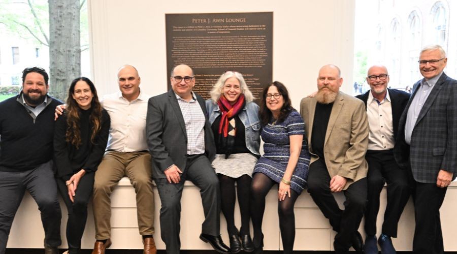 Columbia GS Dean Lisa Rosen-Metsch and the family of Dean Emeritus Peter J. Awn in front of the newly unveiled plaque dedicating the lounge space in Lewisohn Hall to Dean Awn.