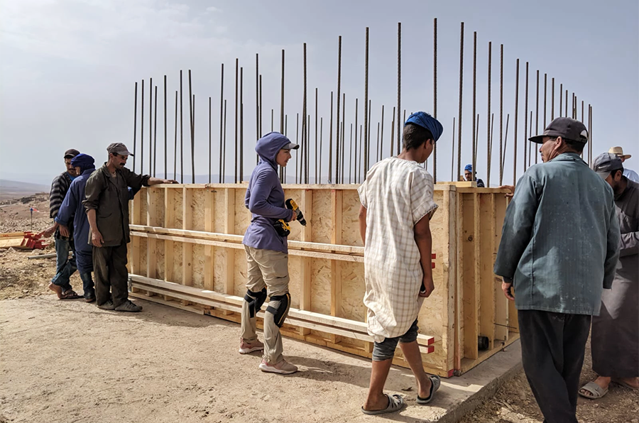 Rachel Ballew and others work on constructing a building