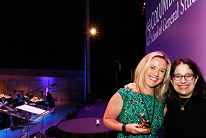 Kirsty Jardine '15 poses with Dean Lisa Rosen-Metsch on stage