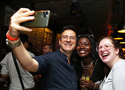 Three attendees pose for a selfie at the GSAA Welcome Reception