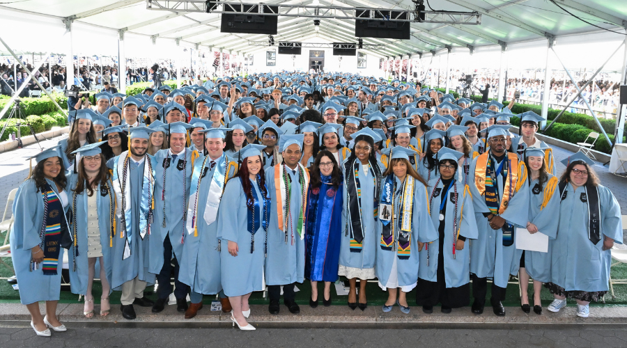 The GS Class of 2025 pose for a group photo with Dean Lisa Rosen-Metsch