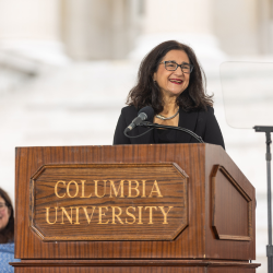 President Shafik standing at the podium