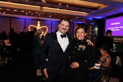 two guests at the military ball, one in uniform and the other in a suit