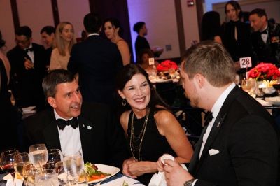 three seated guests at the military ball
