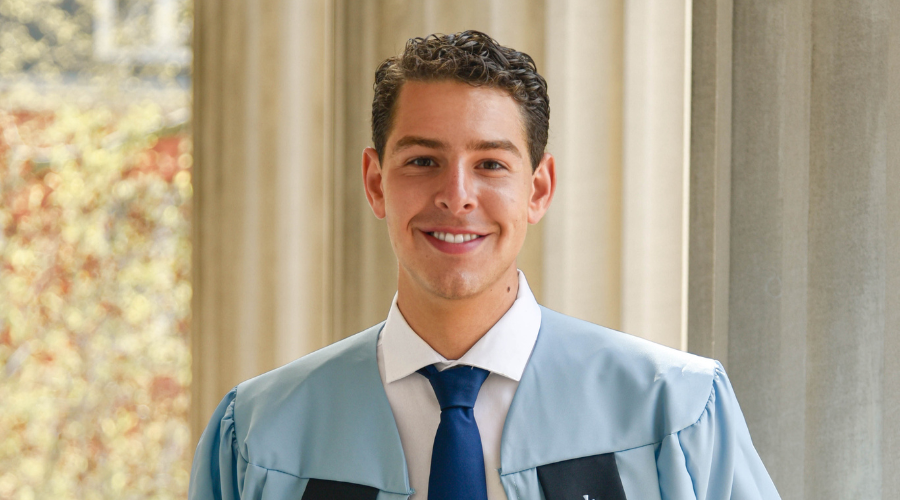 Christian Rodgriguez poses in graduation robe