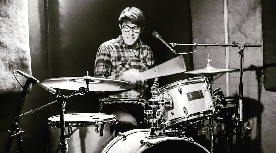 Black-and-white photo of Ivan Dominguez playing the drums