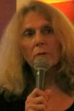 Carla Stockton '73GS holding a microphone