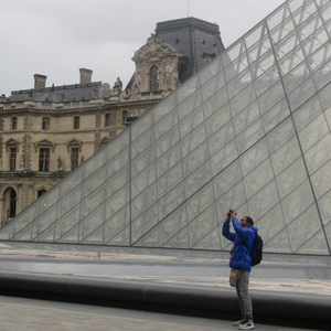 Participant in “Within and Without: Gazing Through the Migrant’s Lens” taking a photo at the Louvre