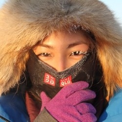 Marin wearing a coat and UNIQLO gear, with snowy eyelashes 