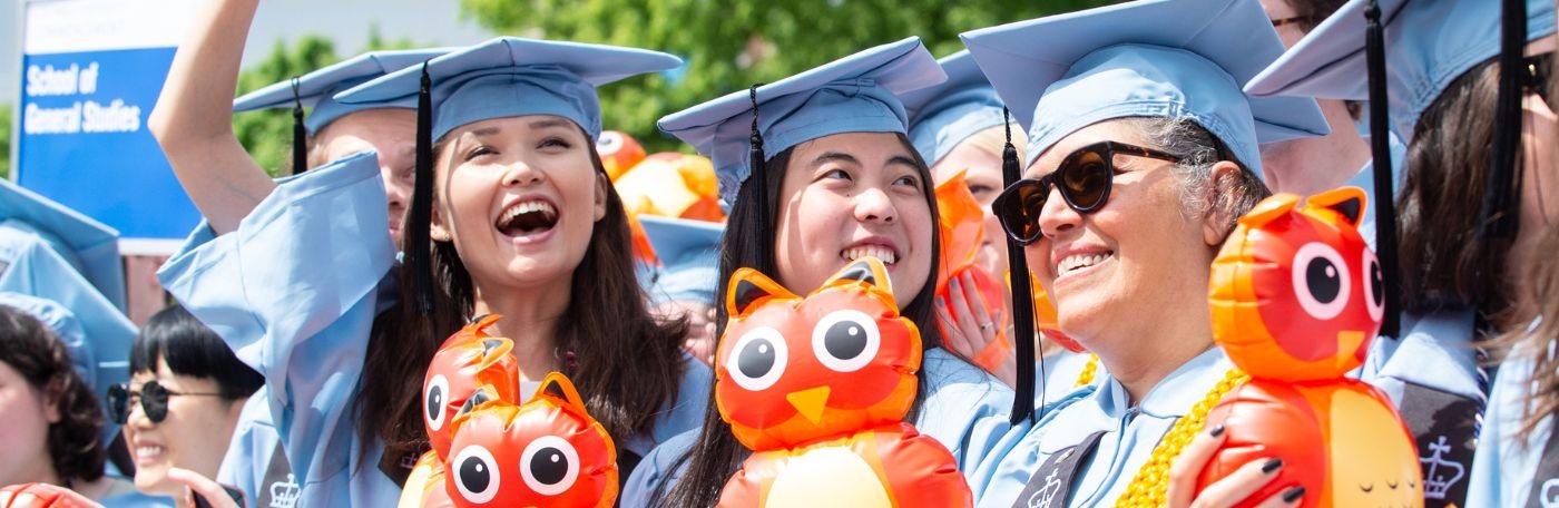Three 2022 GS graduates at Commencement with the GS Owl Balloons