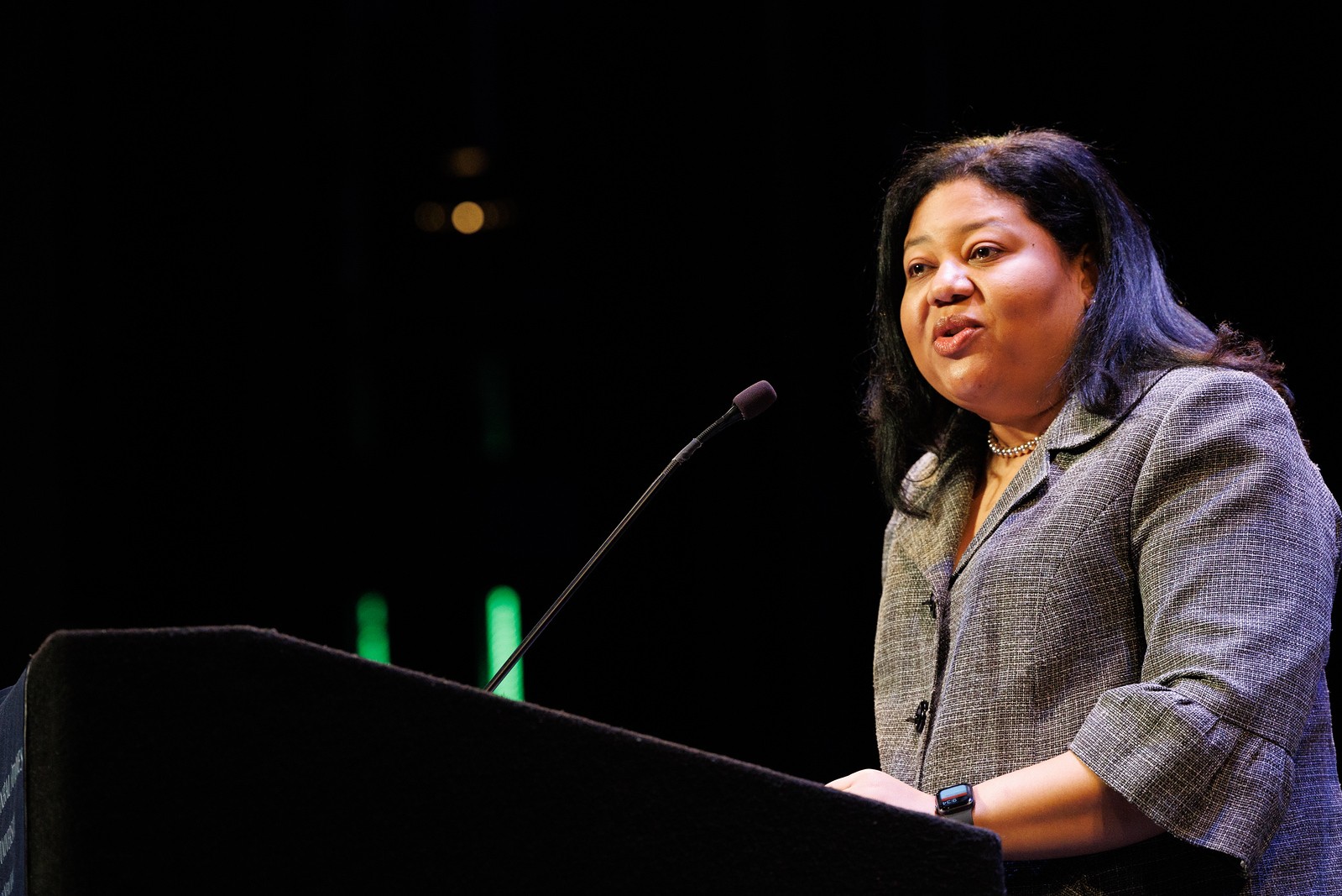 Shot of Dean Marlyn Delva on stage addressing students