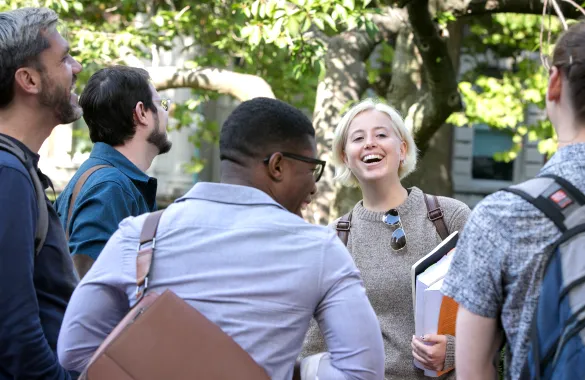 Group of GS students laughing on campus