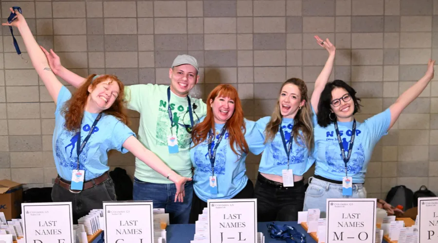 Columbia GS orientation leaders at a new student check-in table during Convocation.