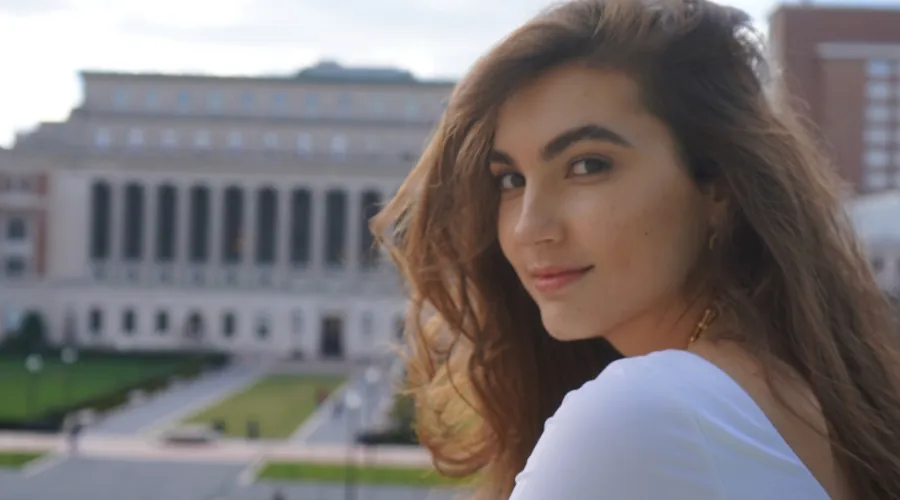 Krista Kalaj '25GS headshot in front of Butler Library at Columbia University.