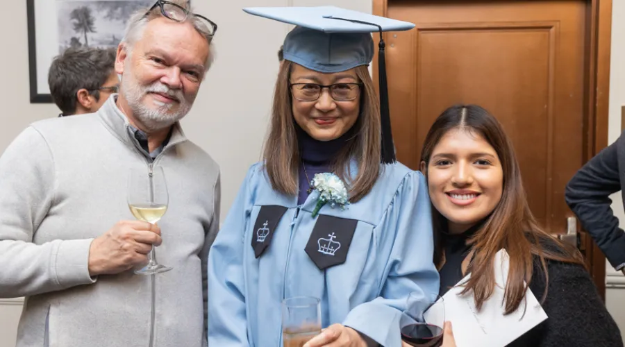 A GS graduate poses with her family at the February Graduation Ceremony.