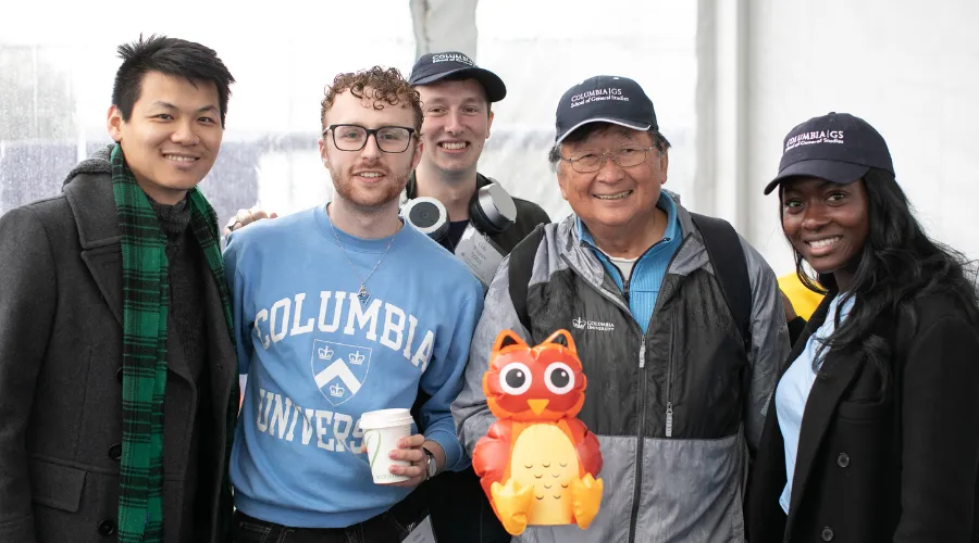 Five GS alumni pose for a photo at the Homecoming festivities
