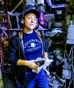 Mariclaire Joseph '23GS in a Columbia t-shirt in an engine room