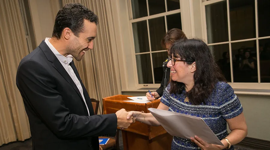 Dean Rosen-Metsch hands award to Honor Society inductee