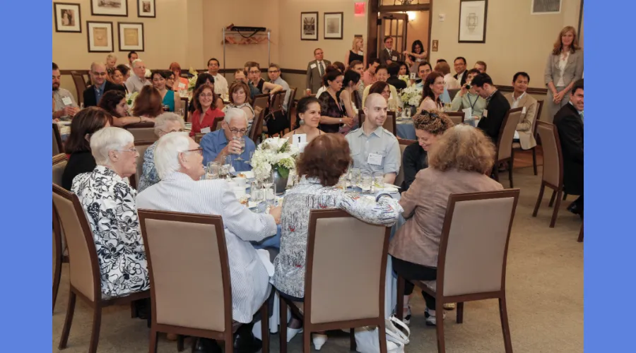 GS alumni sit around a table during a reception for the 2013 Alumni Reunion Weekend