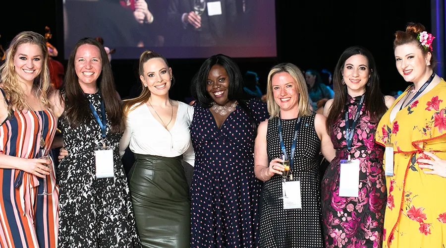 Seven alumni pose for a photo at the 2019 GS Alumni Dinner