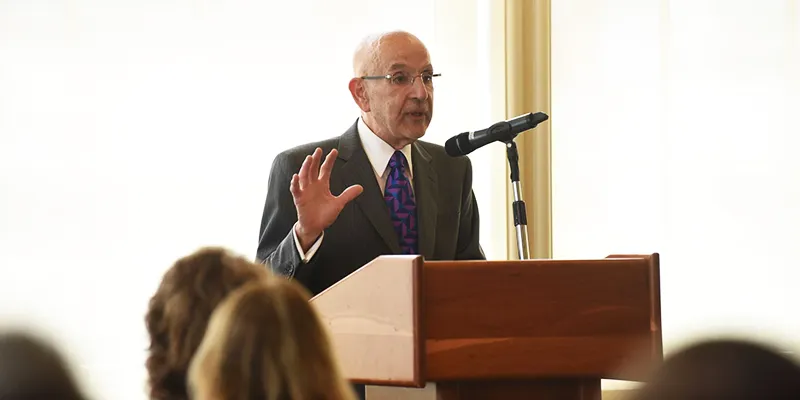 Dean Awn addresses attendees from the podium