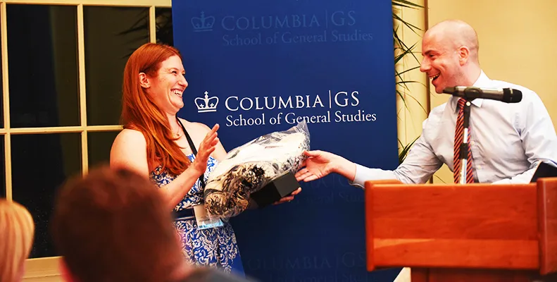Jaysen Medhurst, GSAA Co-Chair, delivers a gift to Mason Beard, outgoing GSAA Co-Chair