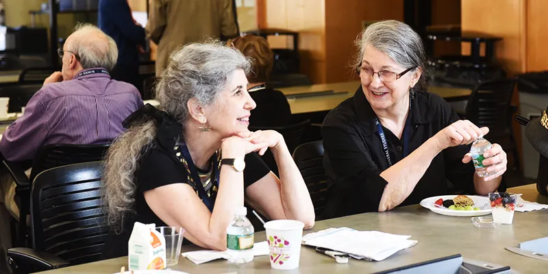 Two GS alumnae share a conversation over breakfast