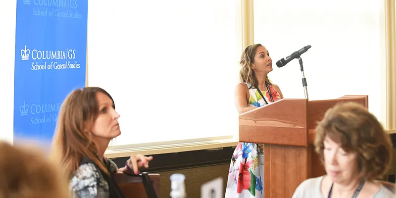 Reunion Co-chair Jessica Garza '09 addresses guests to the Dean's Luncheon at the podium with a GS stanchion in the background