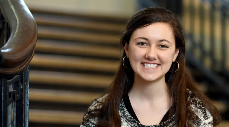 Annie Whitney sitting on the stairs of Lewisohn Hall