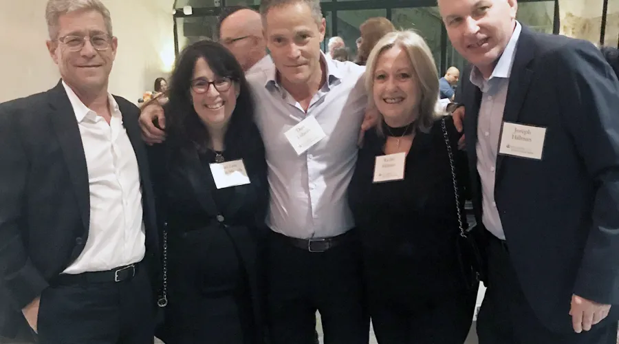 Dean Rosen-Metsch poses for a photo with parents and alumni 