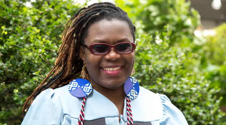 Edna Simbi in her blue Columbia graduation gown