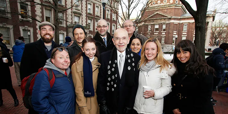 Dean Awn and a group of attendees pose outside of Lewisohn Hall