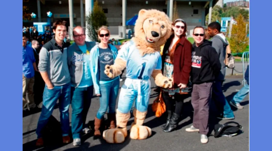 GS alumni poses with a picture with Columbia's Mascot for the Homecoming Game 