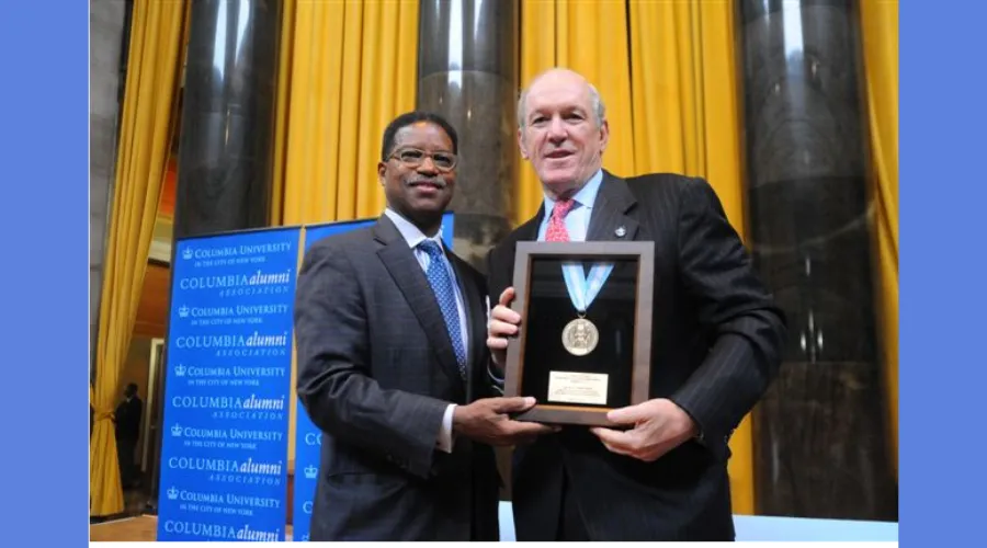 Alumnus Larry J. Lawrence '69 poses for a photo with his award 