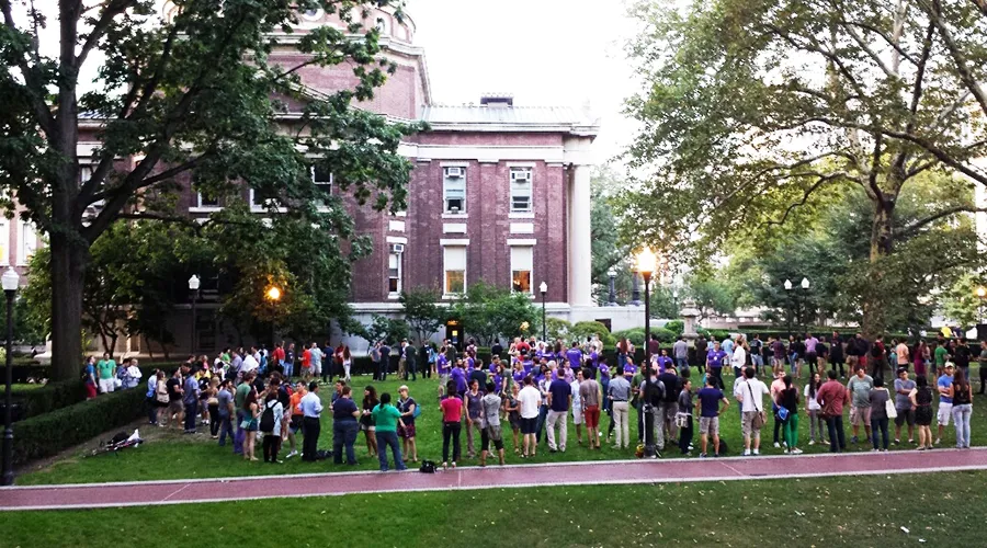 Incoming students gather outside Lewisohn Hall on the lawn with Kent Hall in the background