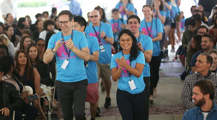 New student orientation leaders cheer as they enter the tents for the New Student Welcome