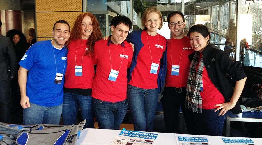 Six Orientation Leaders pose at the Orientation registration table