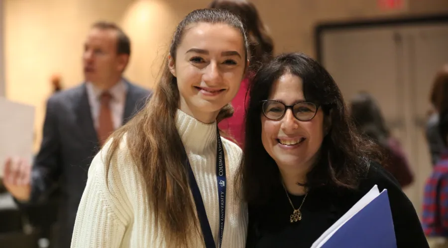 Female student poses for a photo with Dean Rosen-Metsch