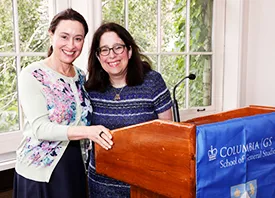 Alumnae Allison Fillmore '97 and Dean Rosen-Metsch '90 pose for a photo at the podium