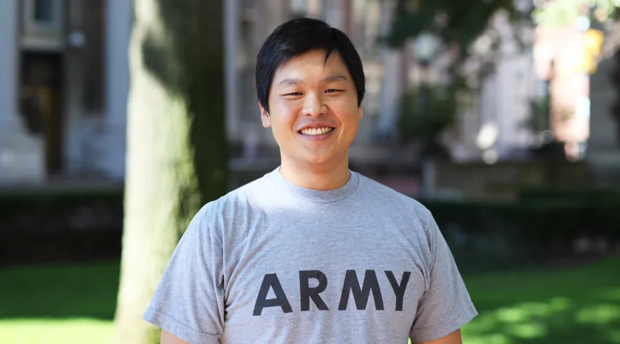 Sang Ra poses outside in an Army t-shirt