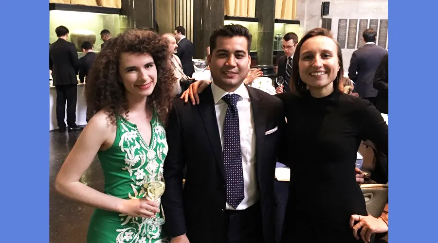 Three students pose for a photo at the ceremony
