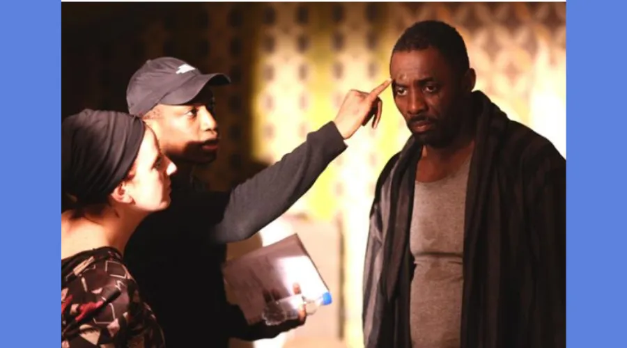 GS alumnus Thomas Ikimi is seen working on set with actor Idris Elba